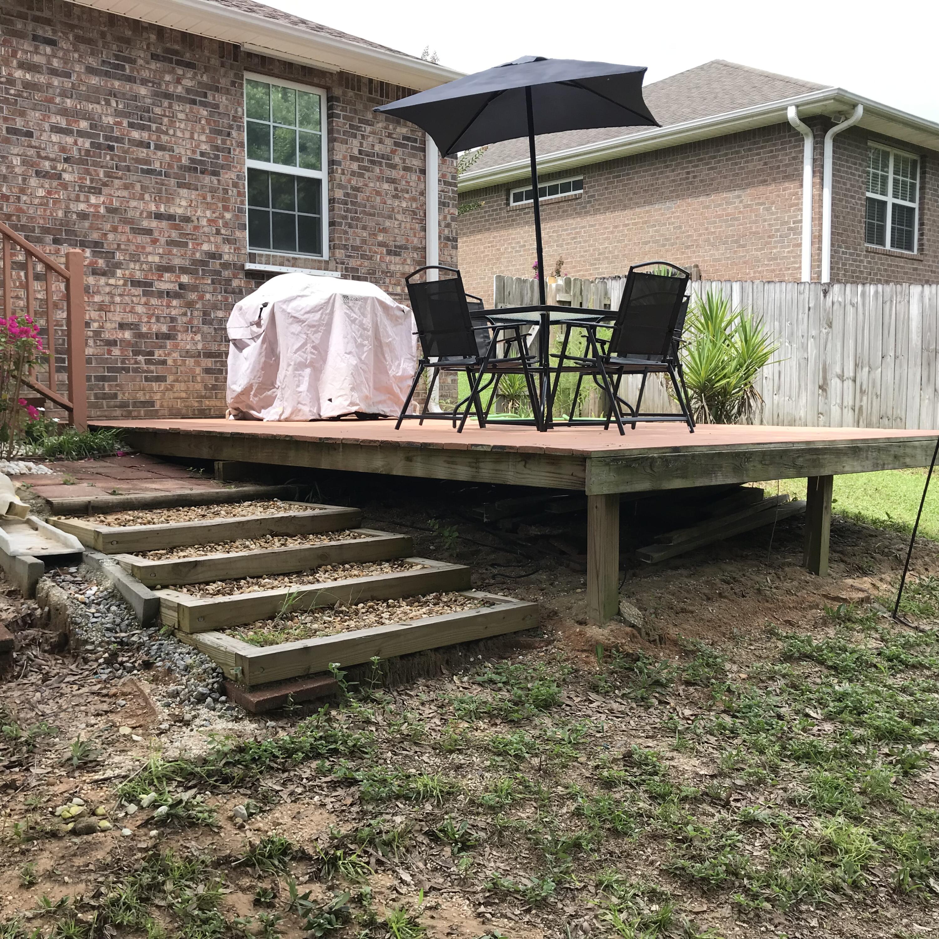 728 Riva Ridge Drive Crestview, FL 32539 - Photo 26 of 26 a backyard of a house with barbeque oven table and chairs