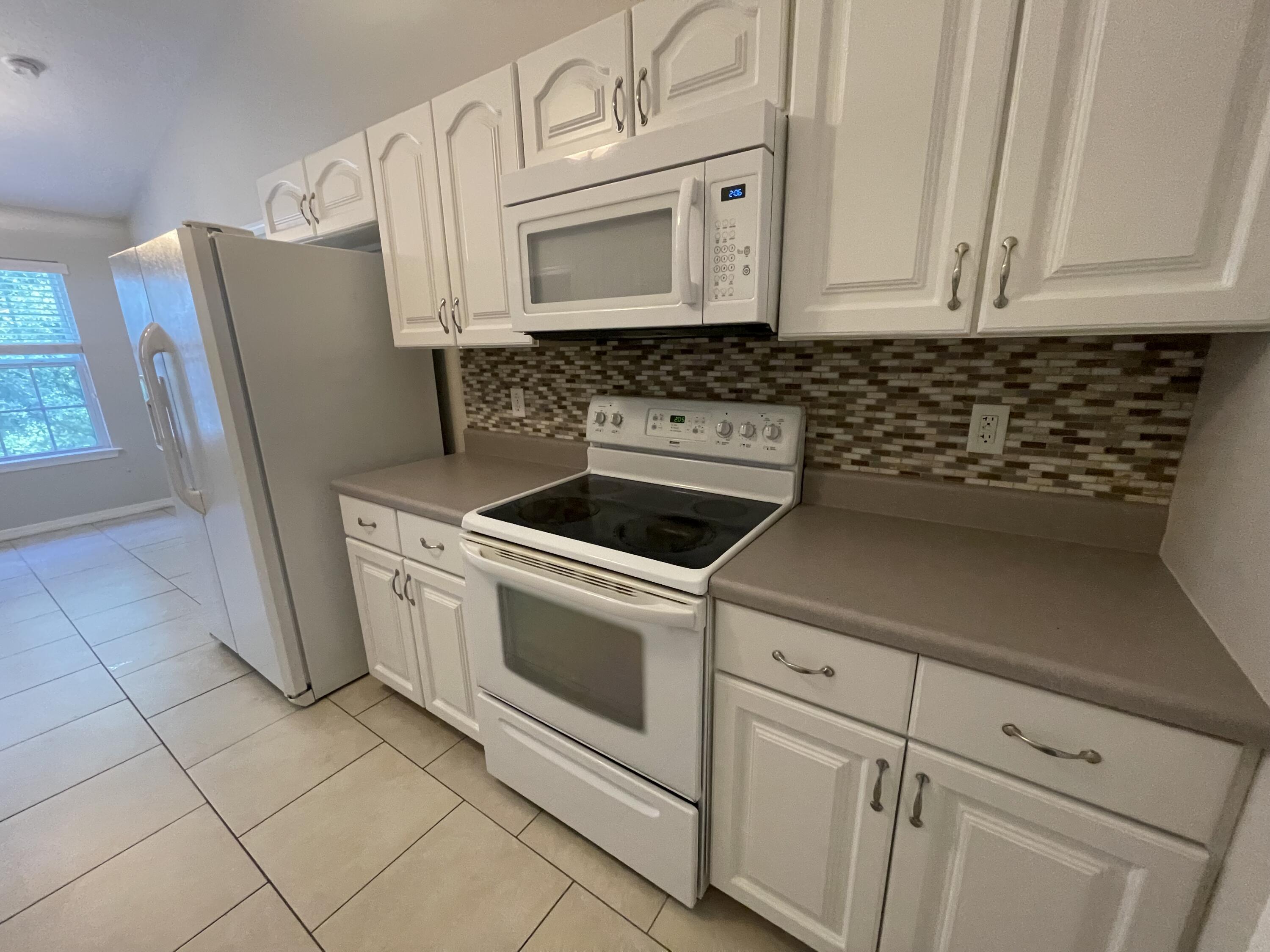 728 Riva Ridge Drive Crestview, FL 32539 - Photo 6 of 26 a kitchen with granite countertop white cabinets and white appliances