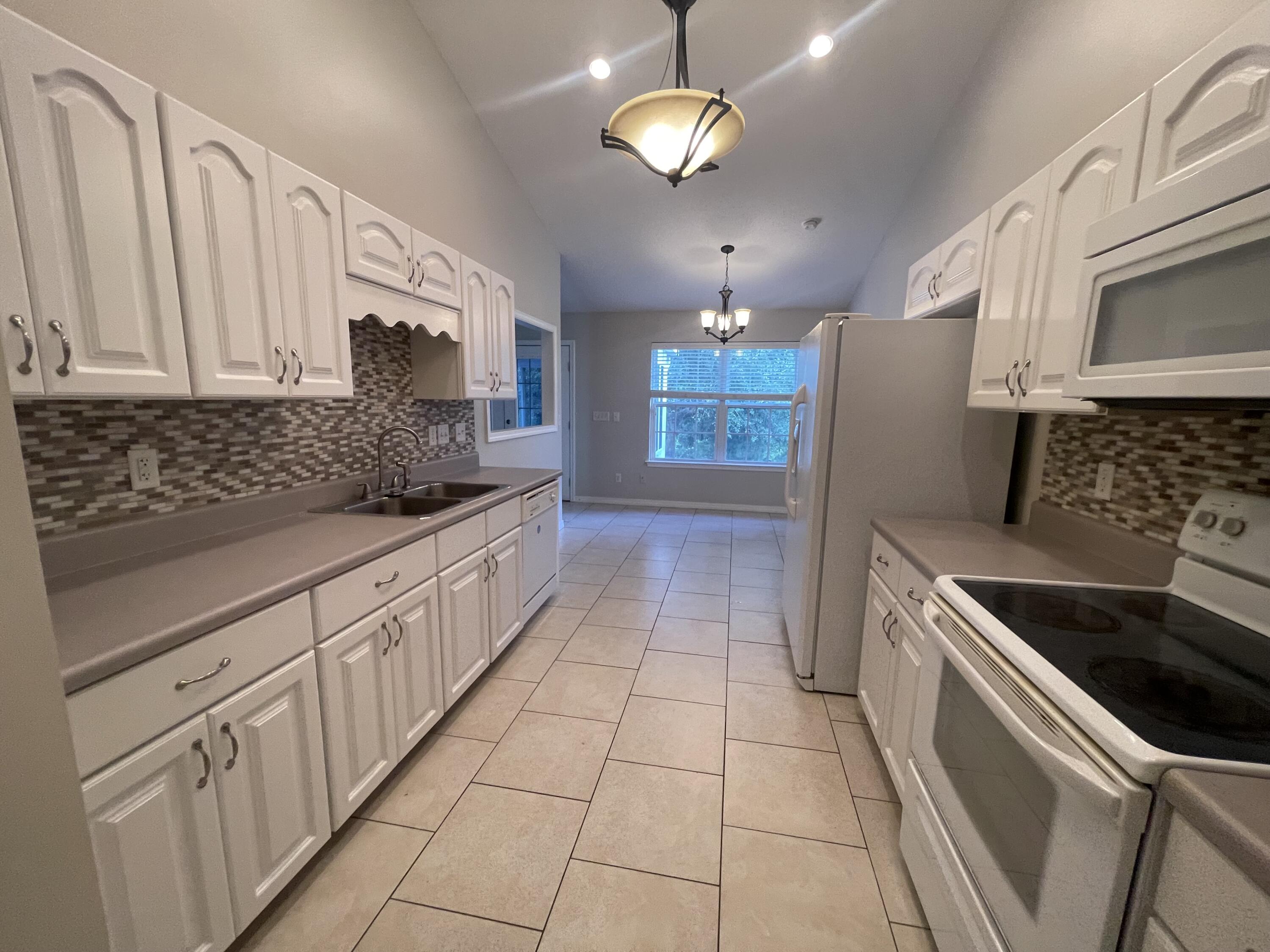 728 Riva Ridge Drive Crestview, FL 32539 - Photo 8 of 26 a kitchen with stainless steel appliances granite countertop a sink and a stove