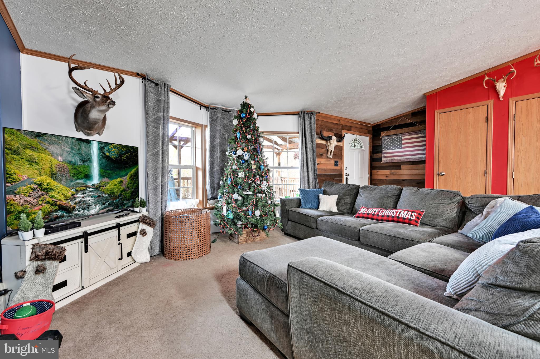 60 Bordnersville Road Jonestown, PA 17038 - Photo 15 of 45 a living room with furniture a flat screen tv and a large window