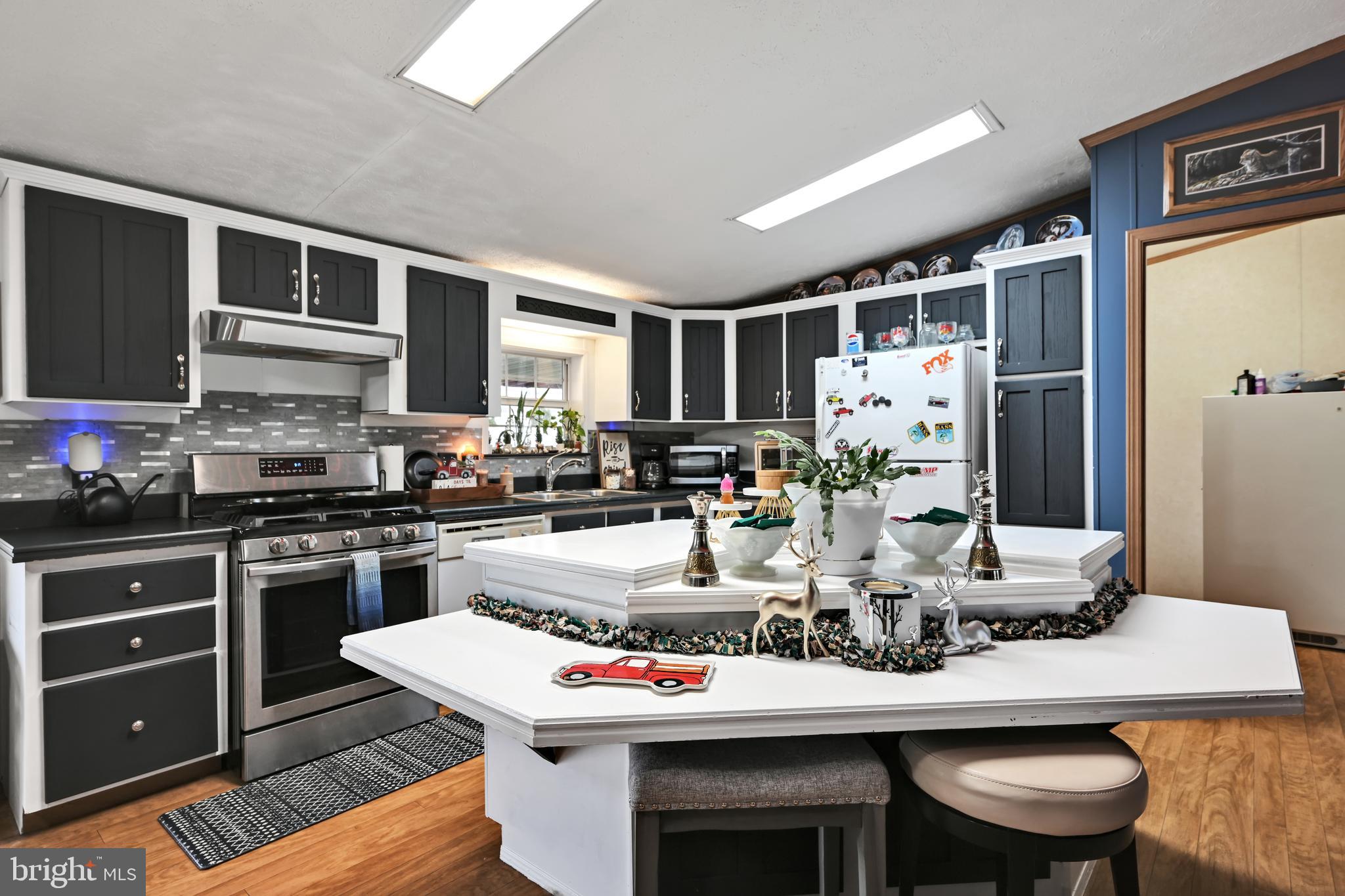 60 Bordnersville Road Jonestown, PA 17038 - Photo 19 of 45 a kitchen with stainless steel appliances kitchen island granite countertop a dining table and chairs