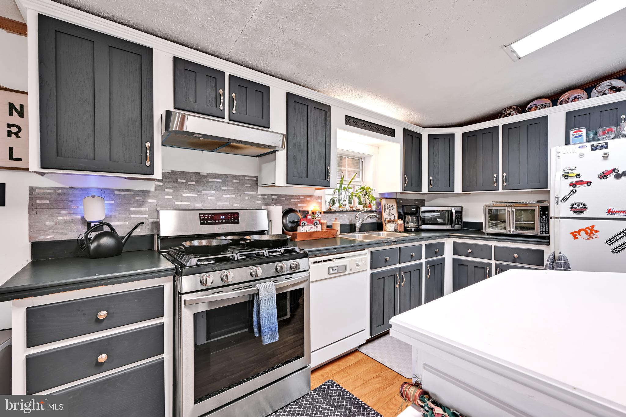 60 Bordnersville Road Jonestown, PA 17038 - Photo 20 of 45 a kitchen with stainless steel appliances granite countertop a stove and a sink