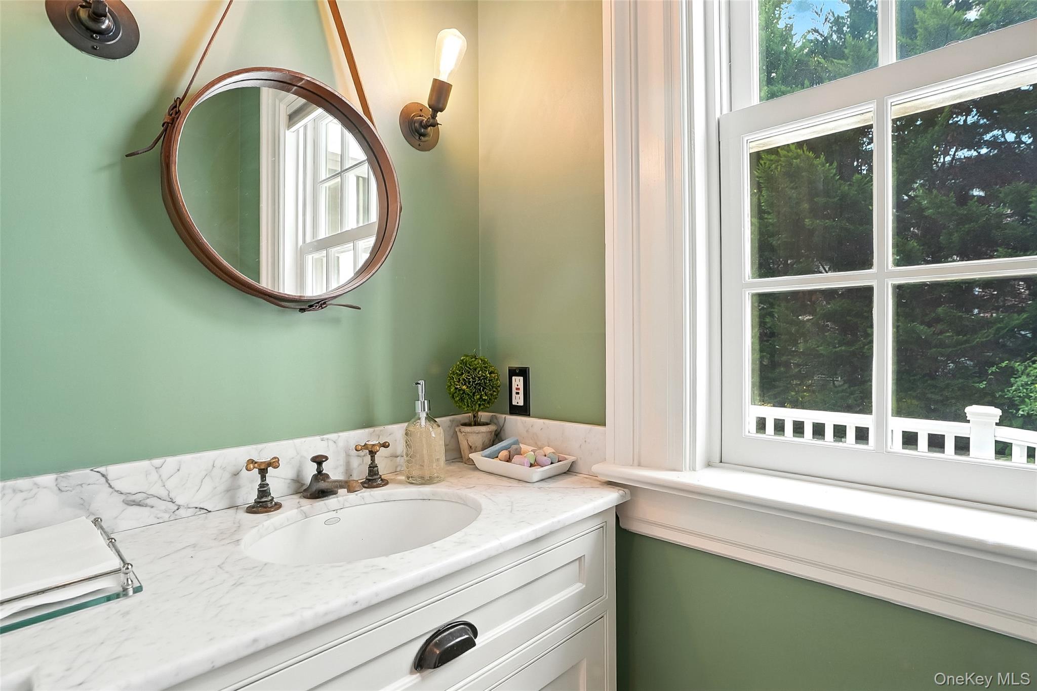 14 Mendota Avenue Rye, NY 10580 - Photo 23 of 33 a bathroom with a mirror and a sink