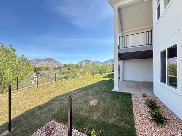 624 North Legend Circle, Unit 480 Mapleton, UT 84664 - Photo 30 of 34 Fenced backyard with a patio, a mountain view, and a balcony