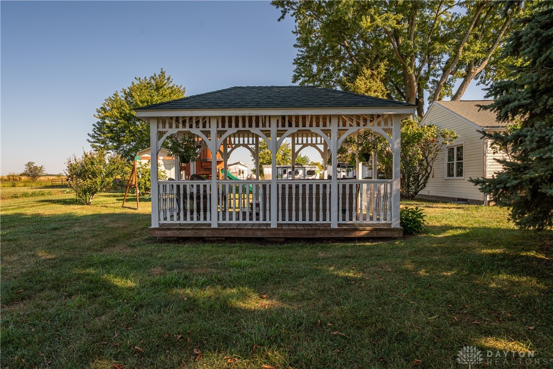 1599 Garringer Road Jamestown, OH 45335 - Photo 39 of 73 An inviting gazebo offers a tranquil outdoor retreat amidst lush greenery.