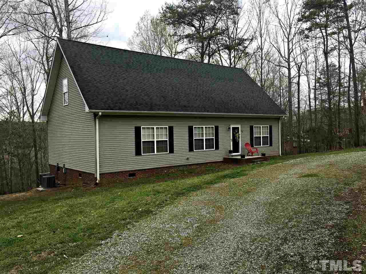 375 Ole Cabin Road Roxboro, NC 27574 - Photo 1 of 11 a house that has a tree in front of it