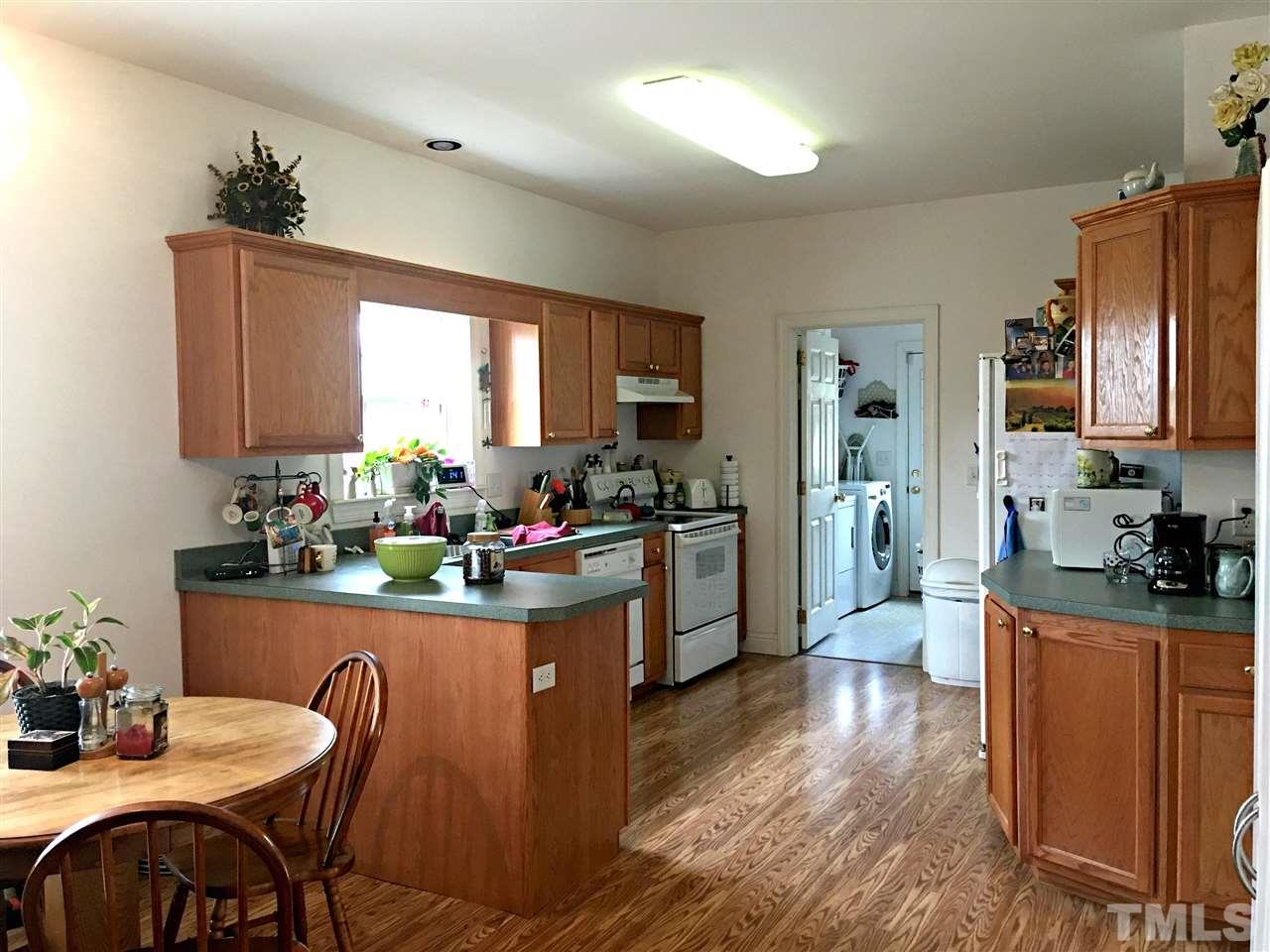 375 Ole Cabin Road Roxboro, NC 27574 - Photo 4 of 11 a kitchen and a dining table chairs in it