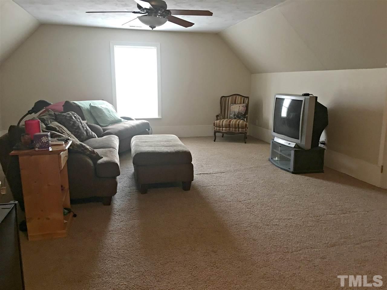 375 Ole Cabin Road Roxboro, NC 27574 - Photo 8 of 11 a living room with furniture a window and a flat screen tv
