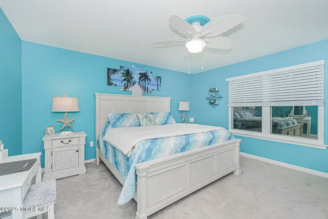 a spacious bedroom with a bed and a large window