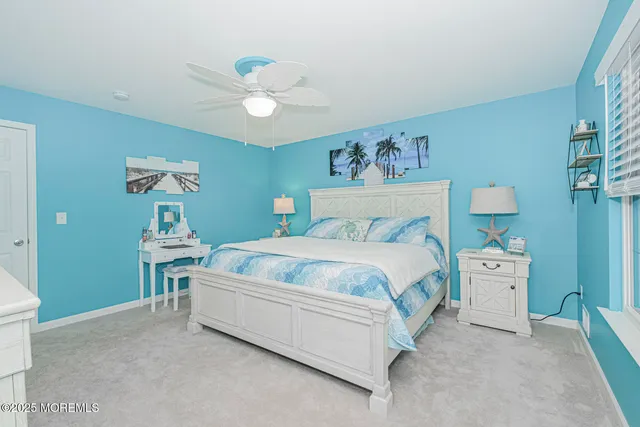a spacious bedroom with a bed a chandelier and a table