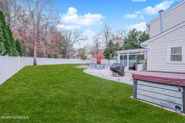 a view of a house with a backyard and a patio