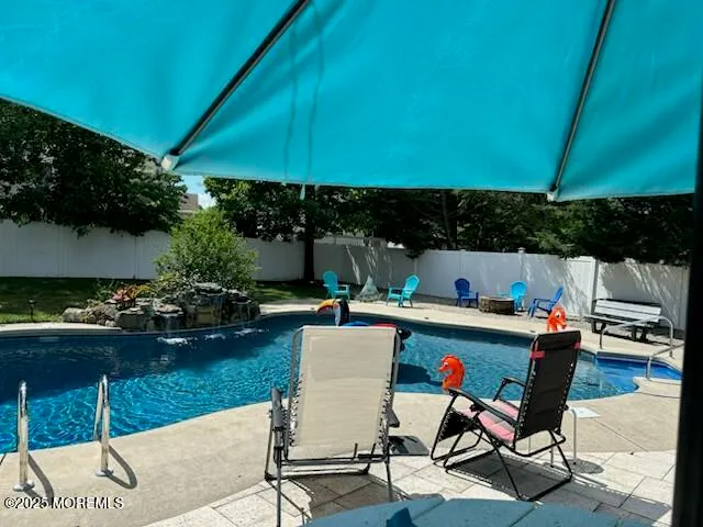 a view of a backyard with sitting area