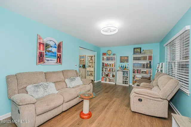 a living room with furniture and a book shelf