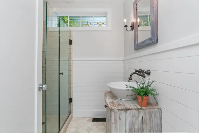 a bathroom with a sink and mirror