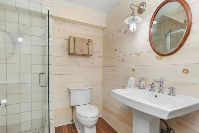 a bathroom with a sink a toilet and a mirror