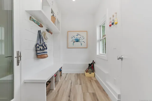 a view of hallway with stairs and wooden floor