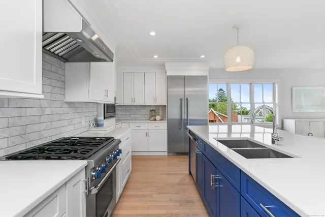 a kitchen with a sink stove and cabinets