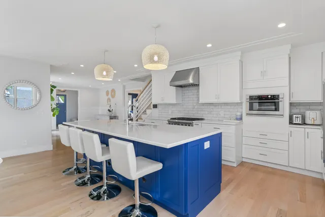 a kitchen with a sink cabinets and wooden floor