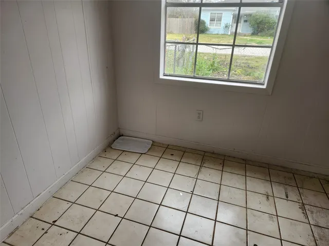 a view of an empty room and a window