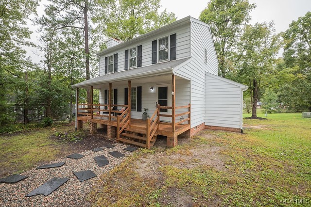 a view of a house with backyard porch and sitting area