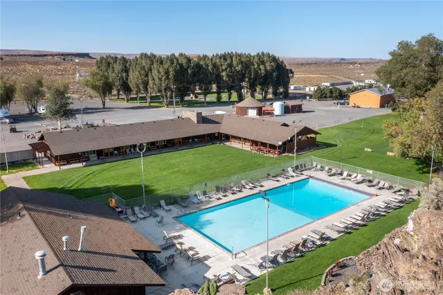 a front view of house with yard barbeque and outdoor seating