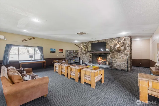 a living room with furniture pool table and window