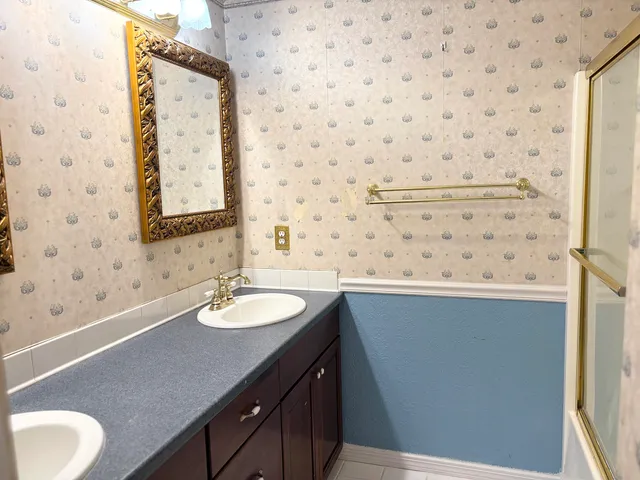 a bathroom with a sink a vanity and a mirror