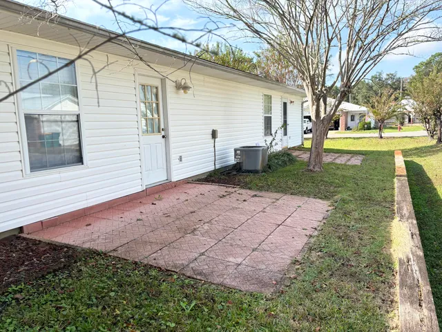 a view of a white house with a yard