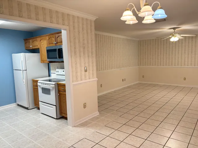 a view of a kitchen with dishwasher and white cabinets