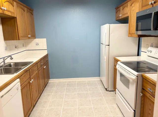 a kitchen with a sink a refrigerator and a stove