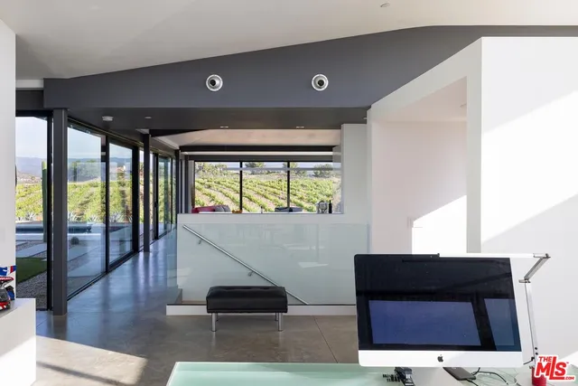 a living room with large window and furniture