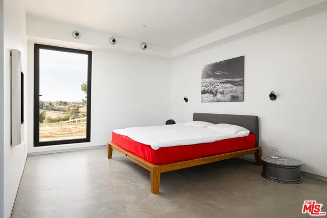 a bedroom with a bed and window