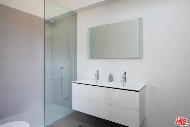 a bathroom with a sink toilet vanity and mirror