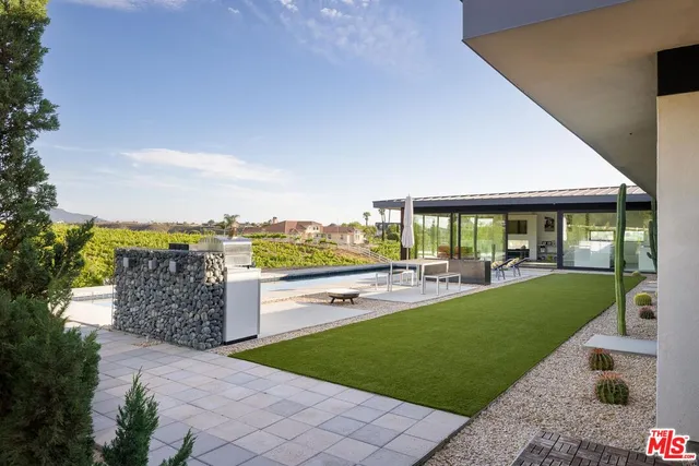 a view of a house with swimming pool and porch