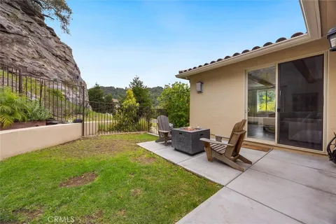 a view of a backyard with sitting area