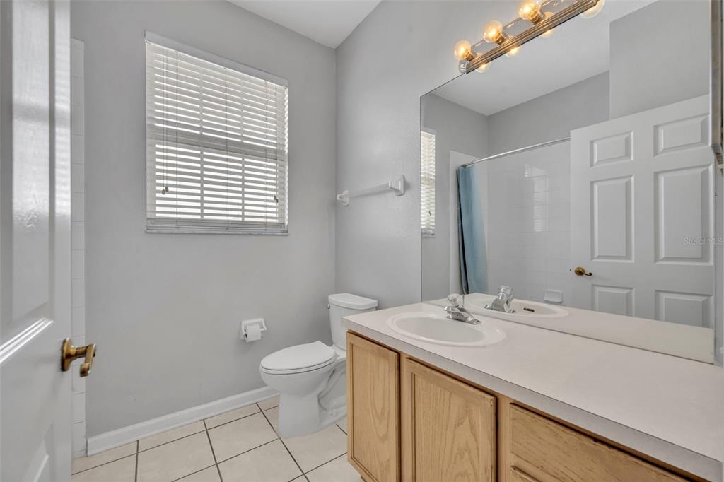 582 Brantley Terrace Way, Unit 304 Altamonte Springs, FL 32714 - Photo 26 of 30 a bathroom with a sink a toilet and a mirror