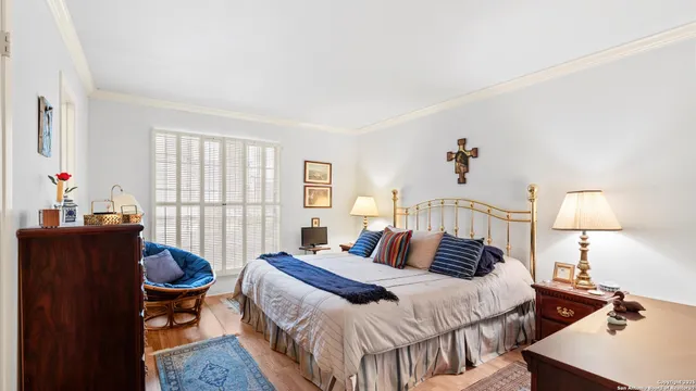 a bedroom with a bed and a large window