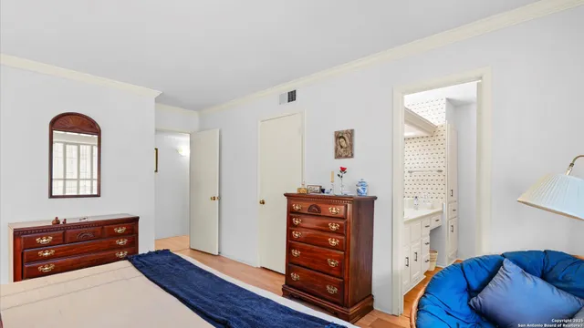 a bedroom with furniture and wooden floor