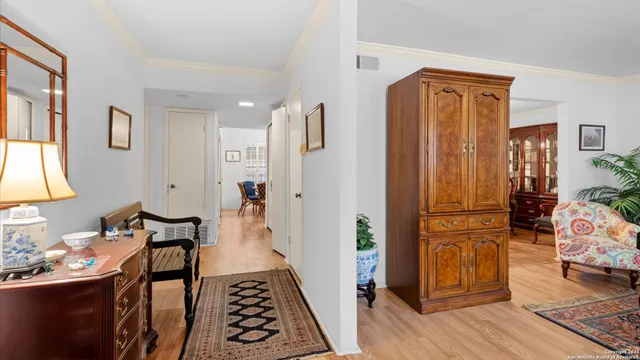 a hallway with furniture and wooden floor