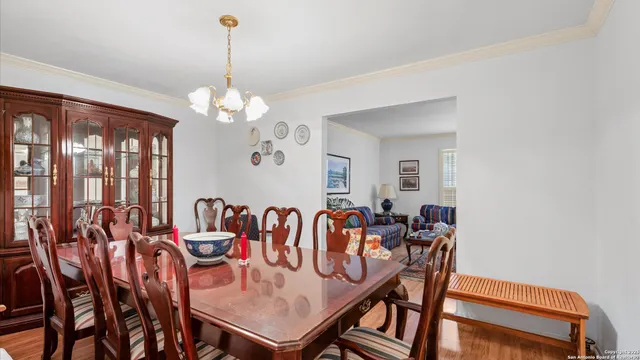 a view of a dining room with furniture and chandelier