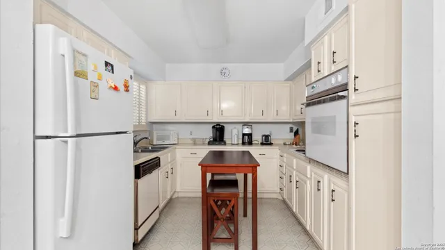 a kitchen with stainless steel appliances a refrigerator sink and cabinets