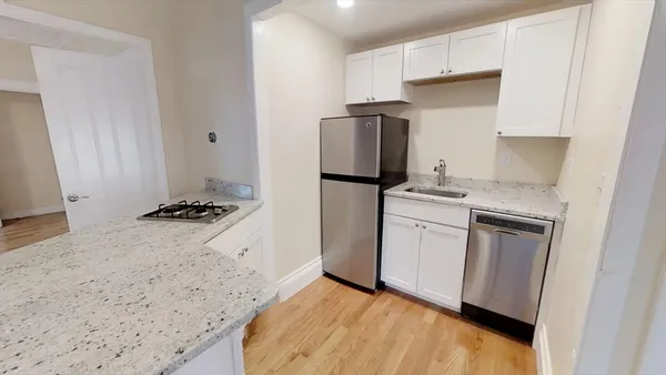 a kitchen with a white cabinets and white appliances