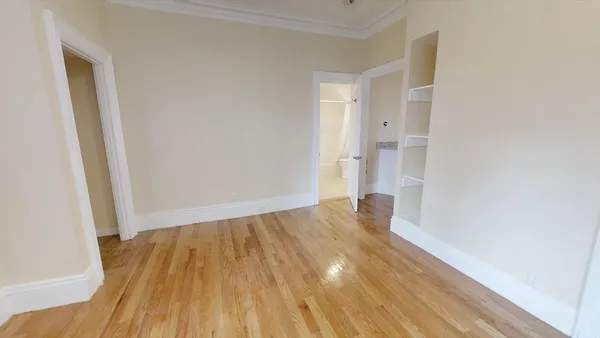 a view of wooden floor in an empty room