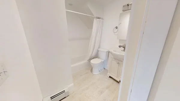 a bathroom with a toilet and a shower