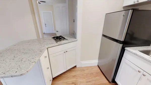 a kitchen with white cabinets and white appliances