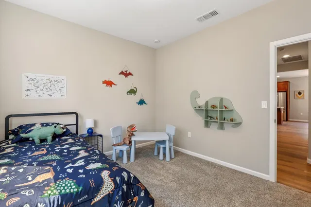 a bedroom with furniture and a potted plant