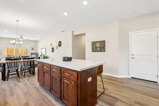 a kitchen with a sink cabinets and wooden floor