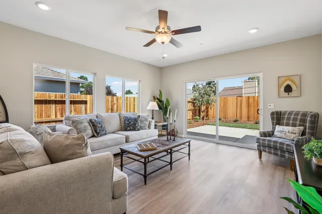 a living room with furniture and wooden floor