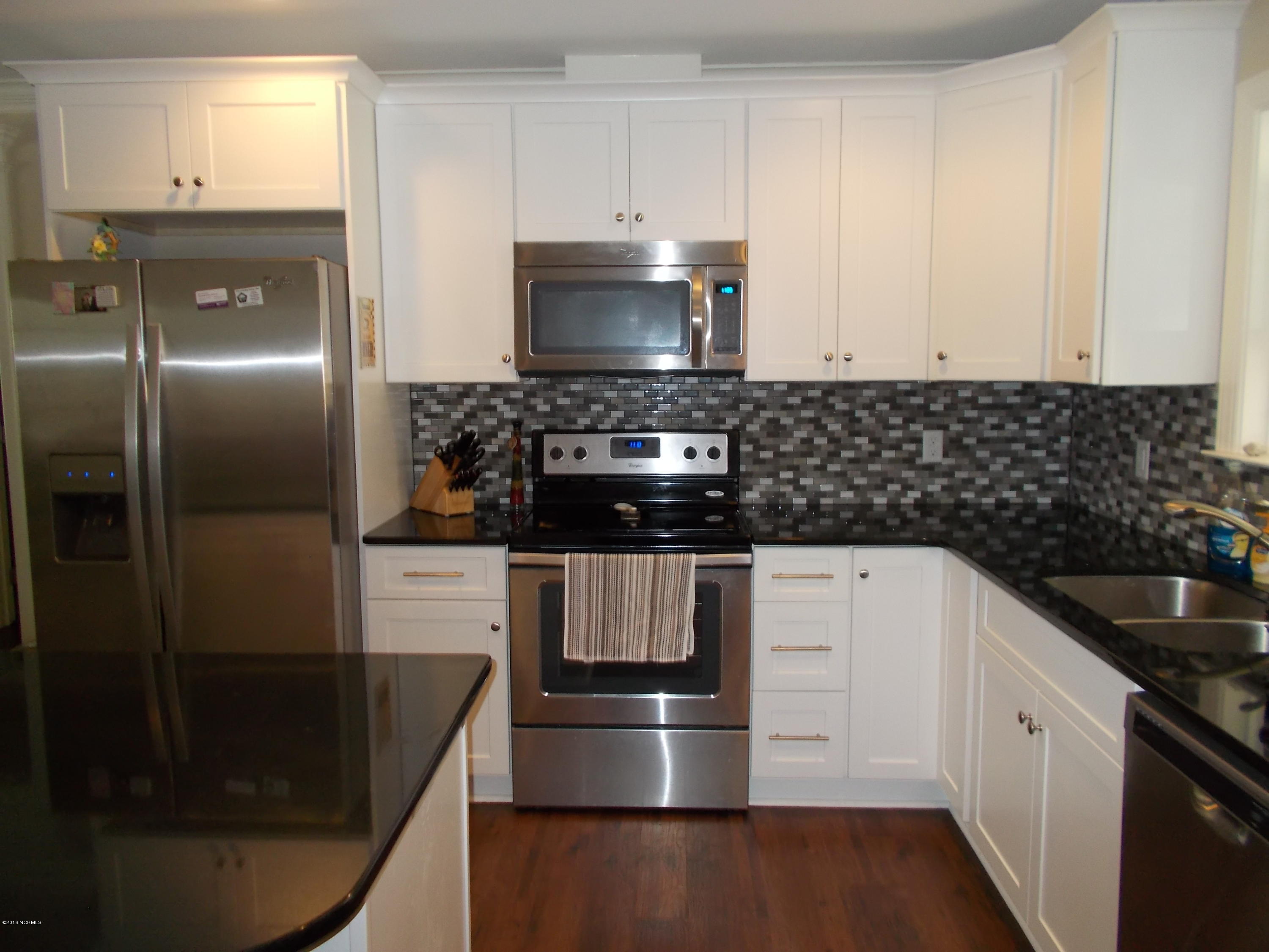 2001 Pinehurst Road Southport, NC 28461 - Photo 16 of 19 white cabinets, black granite counter tops