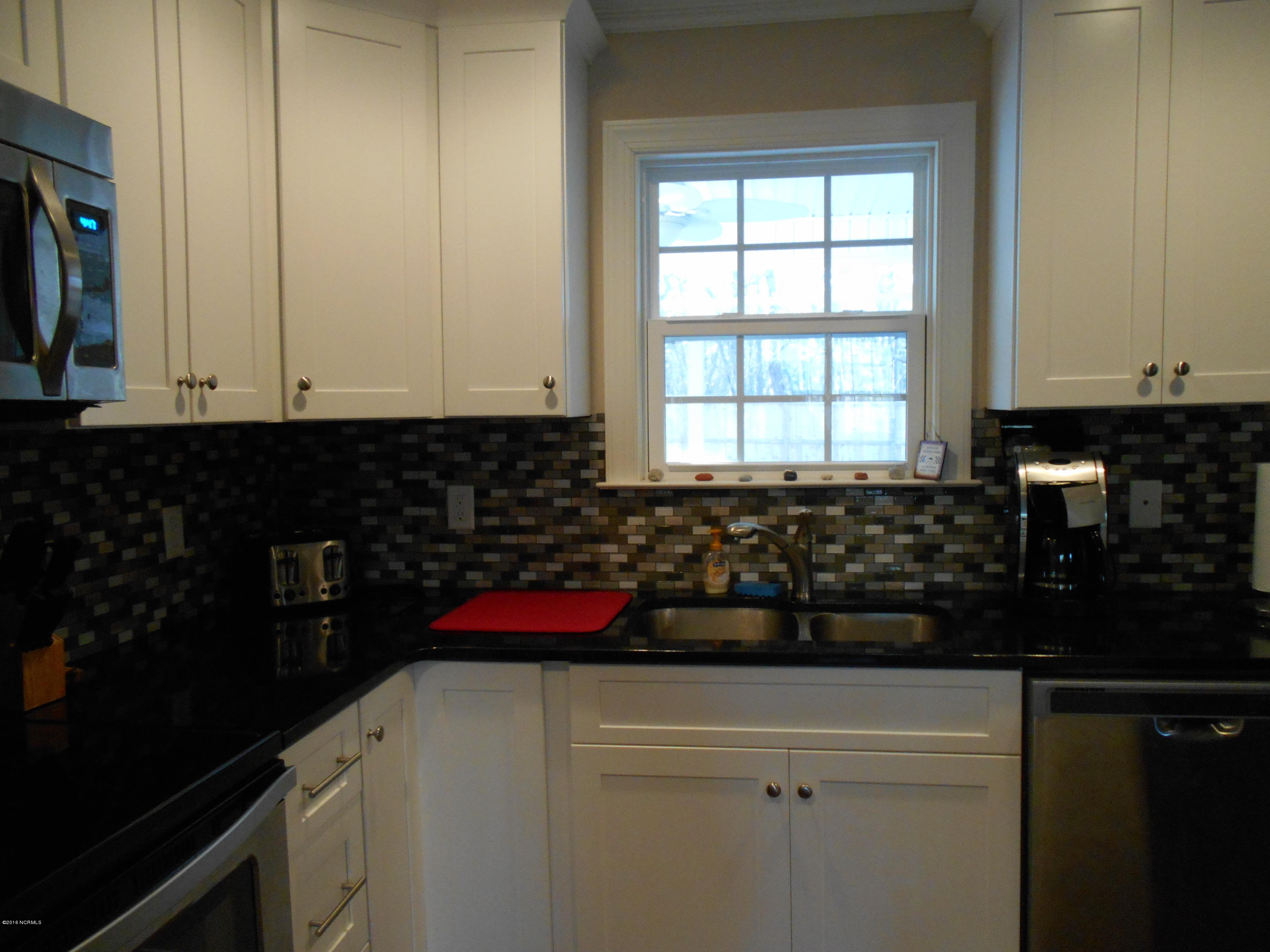 2001 Pinehurst Road Southport, NC 28461 - Photo 8 of 19 window overlooking yard, decorative backsplash